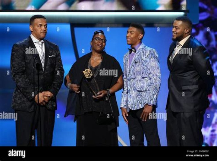 Cecil Newton, Sr., from left, Jackie Newton, and Caylin Newton accept