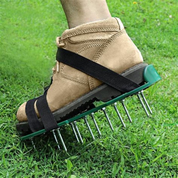 Close-up of lawn aerating shoes with metal spikes