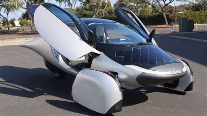 Electric car powered by solar panel on chalkboard