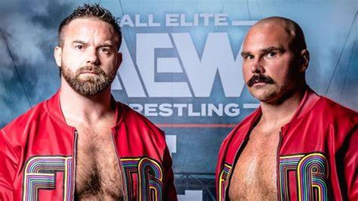 ftr with the aew tag titles holding up their hands