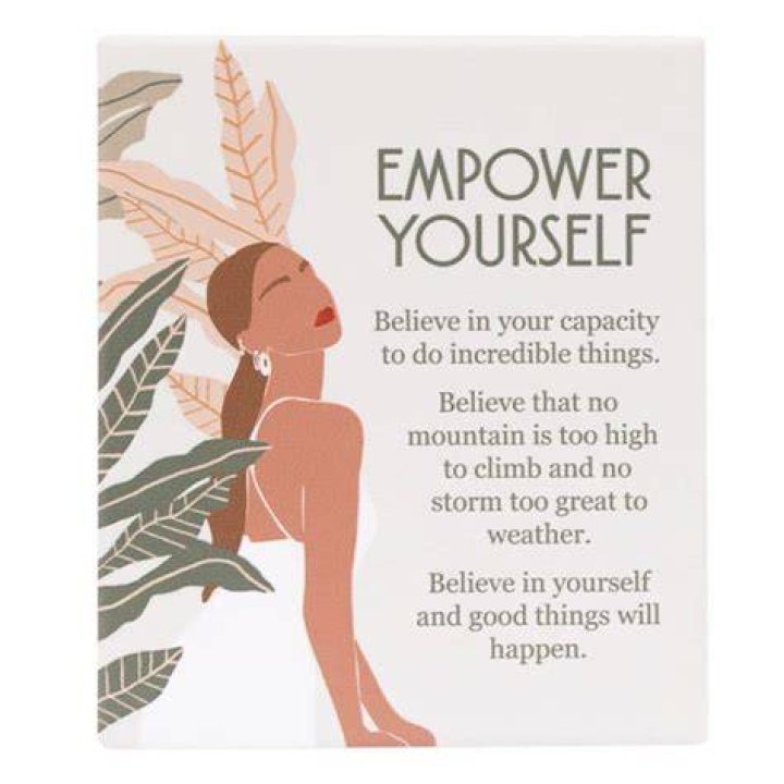 HOW TO EMPOWER YOURSELF Message on the Card Shown by a Businesswoman