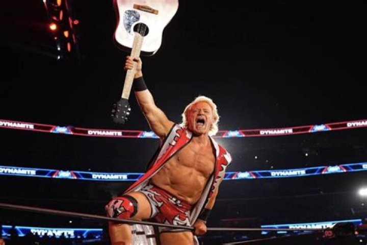 Jeff Jarrett smashes a guitar over Goldust's head