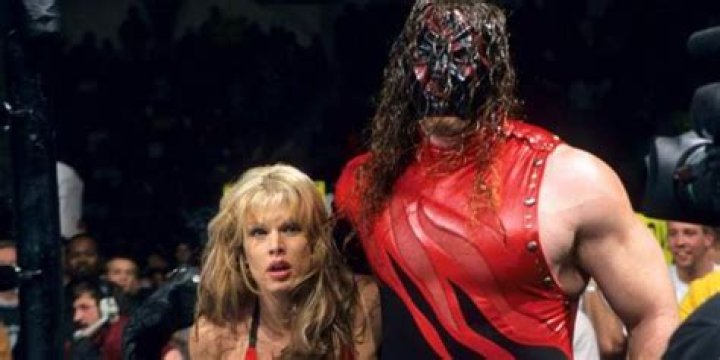 Kane standing with Tori by his side.