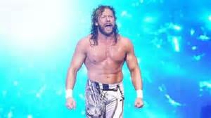 Kenny Omega makes his entrance with a broom