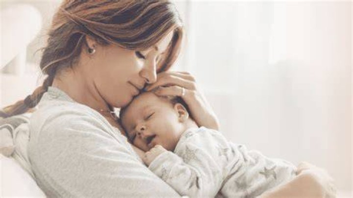 Mother's Warmth. Loving African Woman Tenderly Kissing Her Cute Little