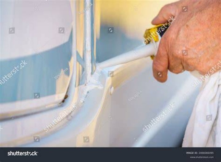 Person Hand Applying chemical Sealant With Silicone Gun