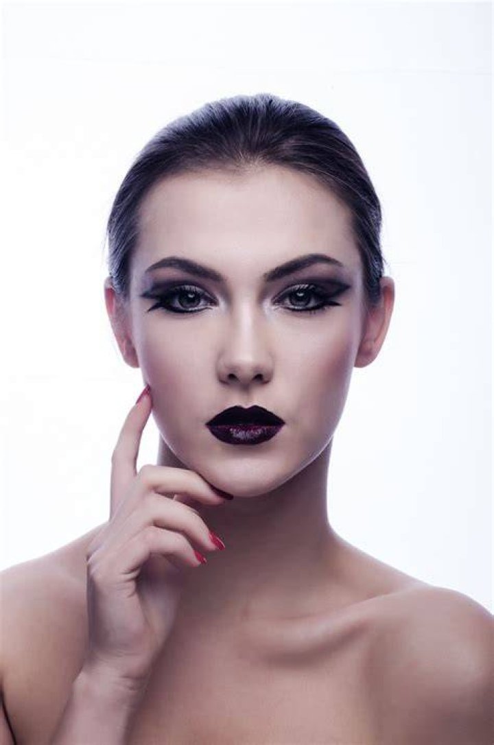 Portrait of beautiful female model on light blue background Photograph