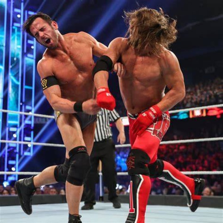 Roderick Strong kicks AJ to break up a Styles Clash on Nakamura