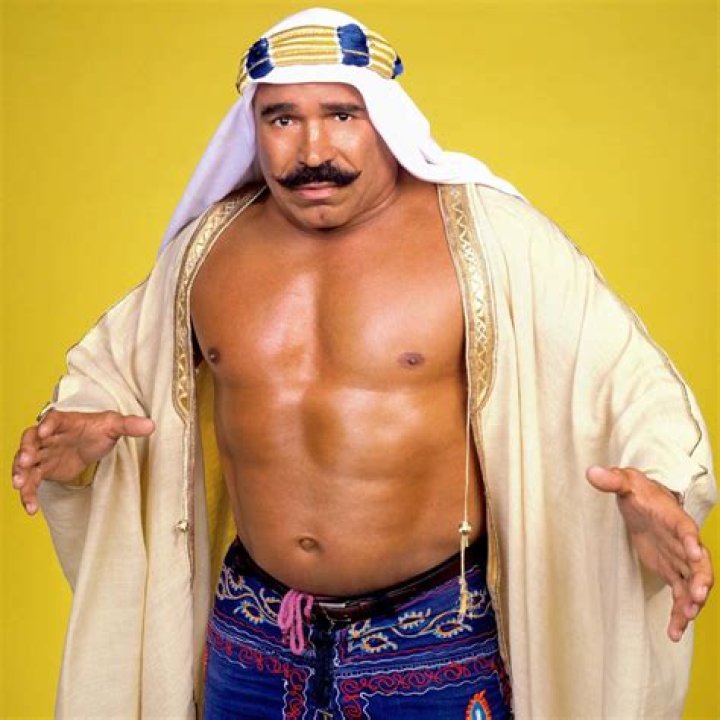 The Iron Sheik wearing the WWE Championship and posing with Fred Blassie.