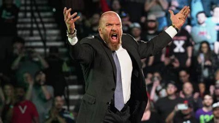 Triple H celebrates his first WWE Championship win